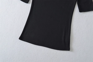 Close-up of stretchy black slim-fit top featuring high-quality double-needle hem stitching