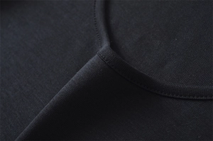 Close-up of low U-neckline with double-stitch detail on black slim fit knit T-shirt