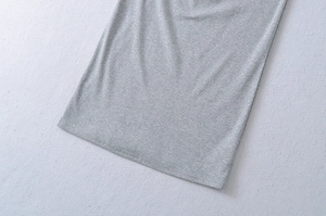 Detail of heather grey knit fabric hem with professional stitching on short sleeve dress