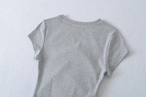 Detailed close-up of gray short-sleeved crewneck dress showing knit fabric texture and seams