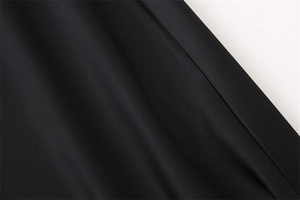 Dettaglio del tessuto in raso di acetato nero con trama fine e cuciture rifinite