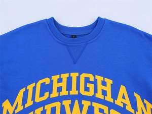 Close-up of royal blue crew neck T-shirt featuring yellow Michigan Midwest varsity print