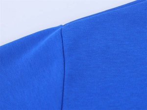 Close-up of royal blue cotton T-shirt shoulder seam showing premium knit texture