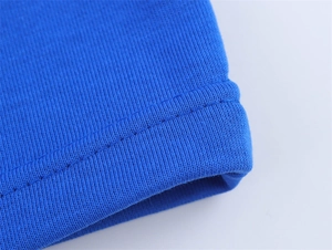 Detailed macro view of royal blue cotton T-shirt sleeve with reinforced double-stitch seam