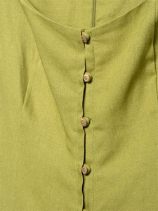 Close-up of lime green linen dress with natural wood buttons and textured fabric