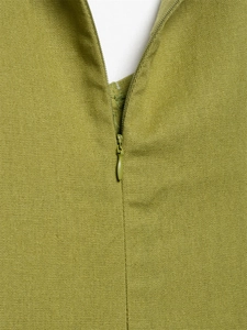 Detailed macro view showing high-quality invisible zipper on a mustard linen midi dress
