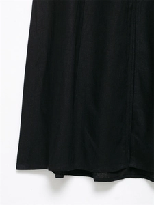 Detailed view of the black linen midi dress featuring precise vertical seam stitching