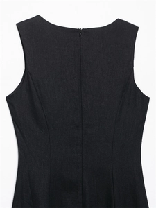 Detail view of the back of a black linen midi dress with invisible zipper and waist darts