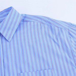 Detail shot of men's polo shirt showing blue striped cotton fabric and collar seams