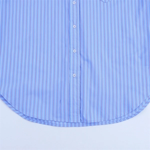 Detail of blue striped cotton shirt featuring white buttons and a curved hem design