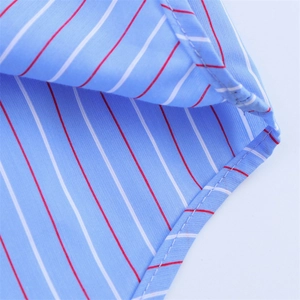 Detailed macro view of the striped cotton fabric and high-quality stitching on the cuff