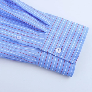 Detailed macro view of light blue striped cotton shirt cuffs with white buttons