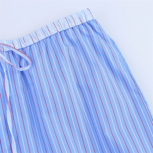 Detail of elastic waistband with white drawstring on blue striped cotton sports trousers