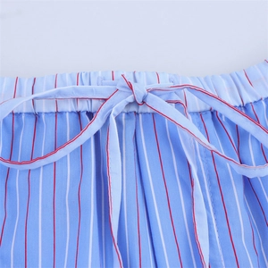 Close-up of elastic waistband with drawstring on blue and white striped cotton pants
