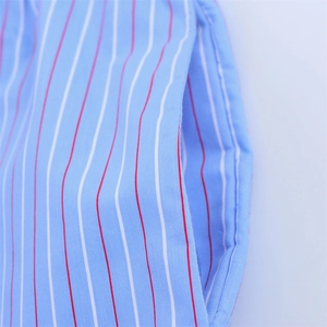 Close-up of blue and white striped cotton fabric featuring a functional side pocket