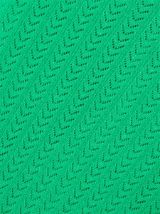 Textura macro de tejido de punto verde con patrón detallado de espiga en forma de V