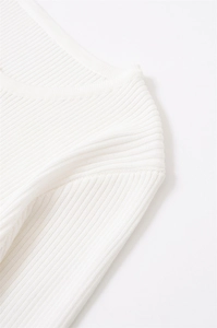 Close-up of premium white ribbed knit fabric showing detailed neckline stitching