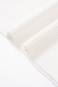 Detailed close-up showing the fine texture and soft rib-knit craftsmanship of the white garment