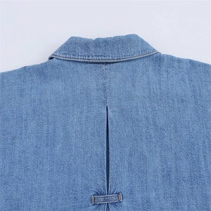 Detail shot of blue denim shirt showing collar design and back pleat craftsmanship