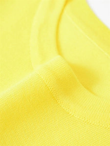 Gros plan sur le haut en tricot jaune vif montrant les détails du col rond de qualité