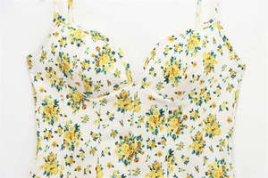 Detailed view of the corset top with yellow floral patterns and fine stitching