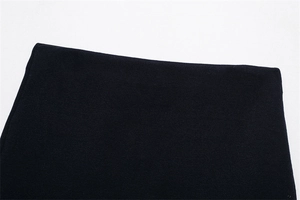 Detailed macro view of the dark navy knitted fabric texture and premium hem stitching