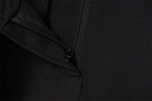 Detail shot of the smooth black zipper and fine twill texture on high waist wide leg pants