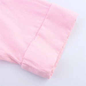 Détail de la manche d'une chemise en lin rose montrant la texture et la couture