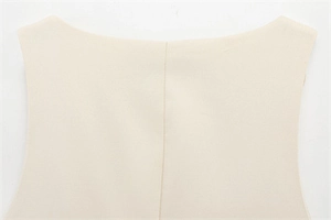 Detailed close-up of the elegant neckline and high-quality stitching on this cream top