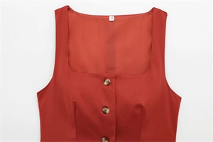 Detail of square neck sleeveless top with brown tortoiseshell buttons in terracotta