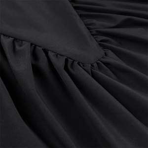 Detail shot of black sleeveless top featuring intricate ruching and twill fabric texture
