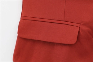 Detail of the flap pocket and fine stitching on a deep red elegant blazer top