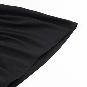 Detailed close-up of smooth black fabric hem with professional stitching and draping