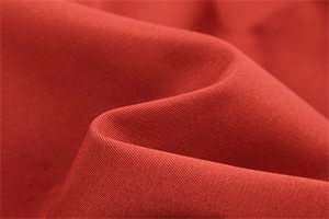 Detailed macro view of high-quality red twill fabric texture for stylish women's clothing