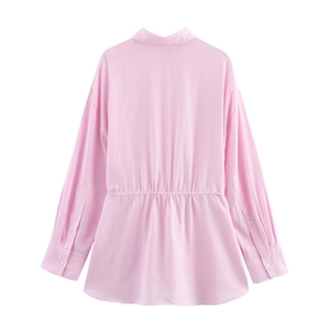 Détail du dos d'une chemise rose à manches longues avec taille élastique ajustée