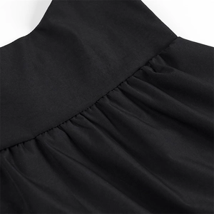 Close-up of gathered waist stitching and pleated texture on black sleeveless tank top