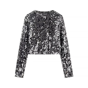 Detail shot of a black and silver sequined cropped top with a shimmering finish