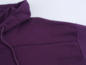 Close-up of deep purple cotton hoodie showing woven drawstring and shoulder stitching