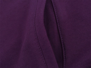 Detailed close-up of dark purple hoodie fabric with professional double-stitched seams