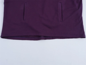 Detail showing side pockets and double-stitched hem on dark purple hoodie sweatshirt