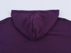 Detailed close-up of the hood stitching and fabric texture on a purple hooded sweatshirt