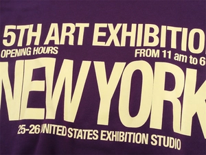 Close-up of screen-printed New York Art Exhibition text on a purple long sleeve hoodie