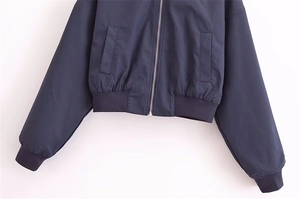 Detailansicht der dunkelblauen Jacke mit Metallreißverschluss und Rippstrickbündchen