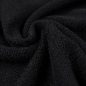 Vue macro détaillée de la texture du tricot noir de haute qualité et des fibres élastiques