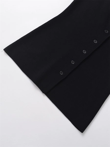 Close-up of black knitted fabric texture with five matching four-hole buttons detail