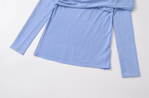 Detailed close-up of light blue knit top featuring soft texture and fine stitching detail