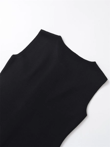 Detailed close-up of black ribbed knit texture on a halter neck sleeveless vest top