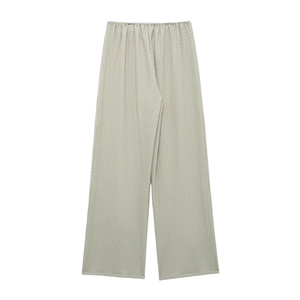 Detail of light beige waffle knit texture on elastic waist wide leg trousers