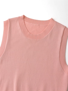 Close-up of pink sleeveless knit vest showing fine ribbed round neck and smooth texture