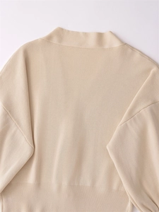 Close-up of ribbed neckline and soft knit texture on beige drop shoulder cardigan